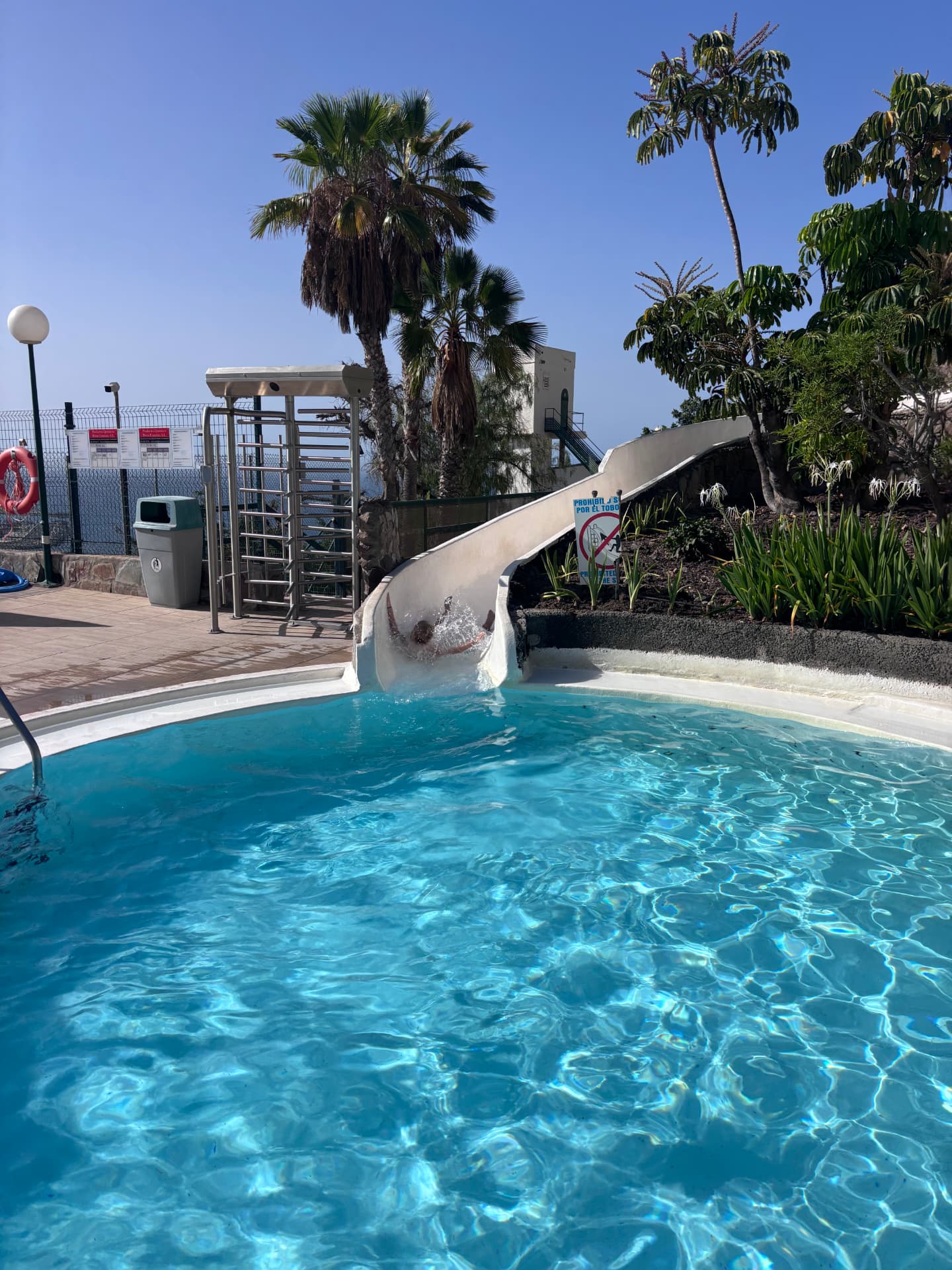 Communal pool area with water slide in the complex