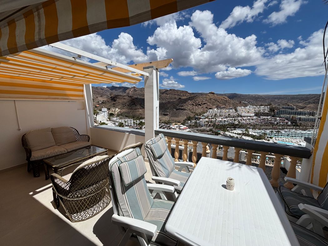 Terrace dining table and seating with views over the bay