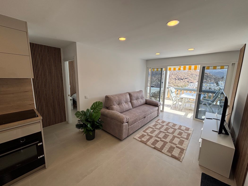 Open-plan living area with sofa and terrace doors